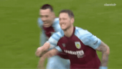 A Soccer Player Is Covering His Face With His Hand While Another Soccer Player Runs Behind Him . GIF