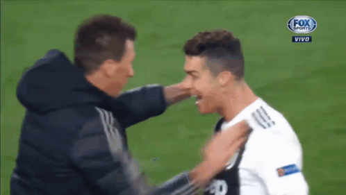A Soccer Player Is Hugging Another Player On A Fox Sports Live Broadcast GIF