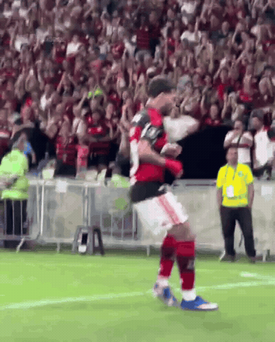 A Soccer Player Is Jumping In The Air On A Field GIF