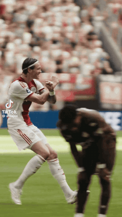 A Soccer Player Is Jumping In The Air While Another Player Watches GIF