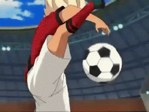 A Soccer Player Is Kicking A Ball In A Stadium GIF