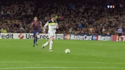 A Soccer Player Is Kicking A Ball In Front Of A Mastercard Banner GIF