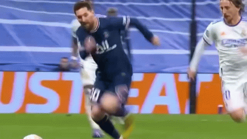 A Soccer Player Is Kicking A Soccer Ball On A Field While Another Player Watches . GIF