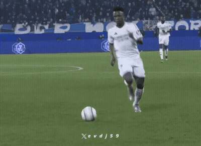 A Soccer Player Is Kicking A Soccer Ball On A Field With A Banner For Crypto.com In The Background GIF