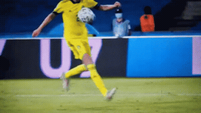 A Soccer Player Is Kicking A Soccer Ball On A Soccer Field . GIF