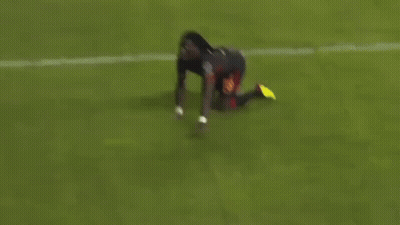 A Soccer Player Is Kneeling Down On The Field . GIF