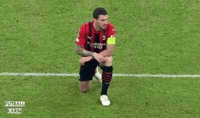 A Soccer Player Is Kneeling Down On The Field During A Match . GIF