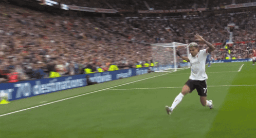 A Soccer Player Is Kneeling On The Field In Front Of A Sign That Says " Fly To Over 70 Destinations " GIF
