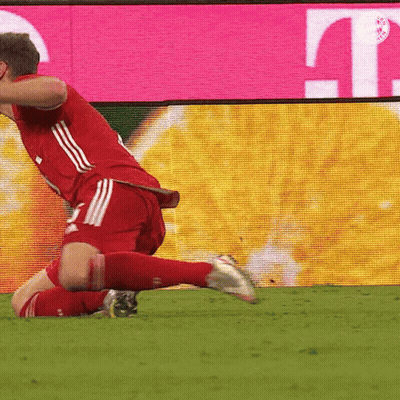 A Soccer Player Is Kneeling On The Field In Front Of A T Mobile Sign GIF
