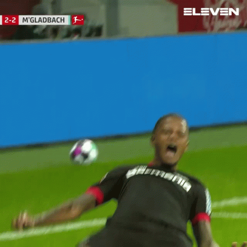 A Soccer Player Is Kneeling On The Field With The Score 2-2 In The Background GIF