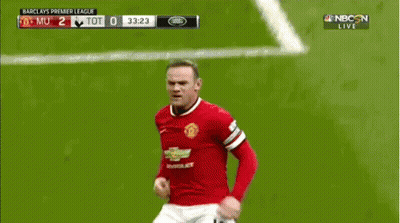 A Soccer Player Is Laying On The Field While Another Player Kicks Him In The Face GIF