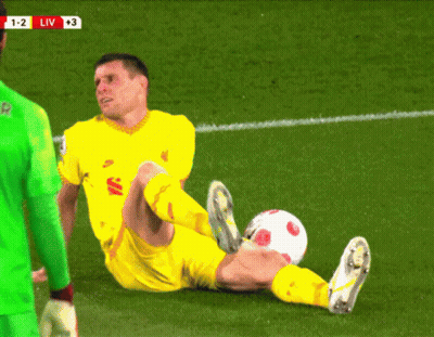 A Soccer Player Is Laying On The Field With The Score 1-2 Liv At The Top Of The Screen GIF