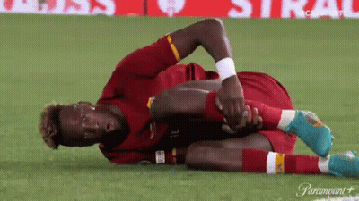 A Soccer Player Is Laying On The Ground Stretching His Arms And Legs GIF