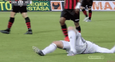A Soccer Player Is Laying On The Ground With His Head Down GIF