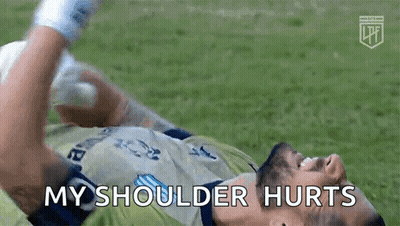 A Soccer Player Is Laying On The Ground With His Shoulder Hurting GIF
