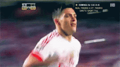 A Soccer Player Is Running In Front Of A Tv Screen That Says Domingo On It GIF