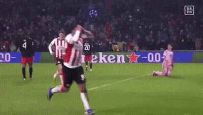A Soccer Player Is Running On A Field With A Heineken Sign In The Background GIF