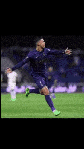 A Soccer Player Is Running On A Field With His Arms Outstretched GIF