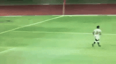 A Soccer Player Is Running On A Green Field GIF