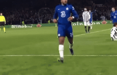 A Soccer Player Is Running On A Soccer Field With A Ball In His Hand . GIF