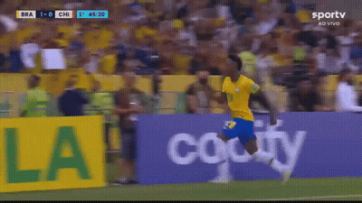 A Soccer Player Is Running On The Field In Front Of A Banner That Says Ola GIF