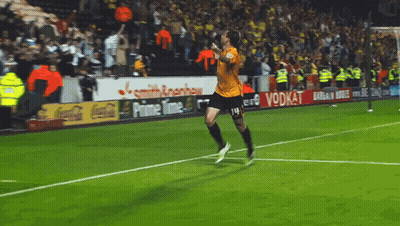 A Soccer Player Is Running On The Field With Ads For Coca Cola And Prime Time In The Background GIF