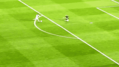 A Soccer Player Is Running Towards A Goal While Another Player Lays On The Ground . GIF