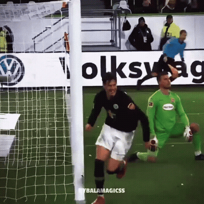 A Soccer Player Is Running Towards The Goal While Another Player Watches GIF