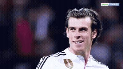 A Soccer Player Is Smiling In Front Of A Hopper Sports Logo GIF