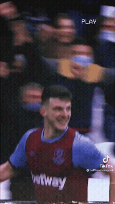 A Soccer Player Is Standing In Front Of A Crowd While Wearing A Purple And Blue Jersey . GIF