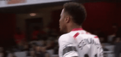 A Soccer Player Is Standing In Front Of A Crowd While Wearing A White Jersey With The Number 11 On It . GIF