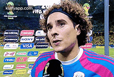 A Soccer Player Is Talking Into A Microphone While Wearing A Headband Sponsored By Visa And Sony GIF