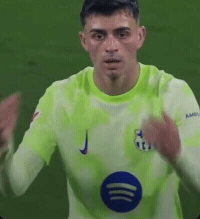 A Soccer Player Is Wearing A Green Jersey With A Blue Circle On The Front . GIF