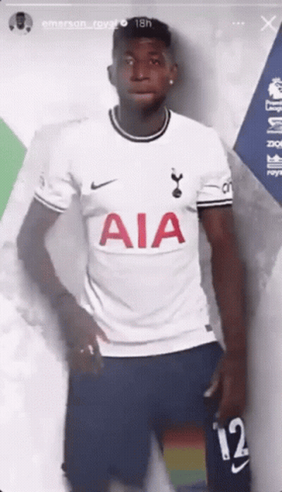 A Soccer Player Is Wearing A White Aia Jersey And Blue Shorts . GIF