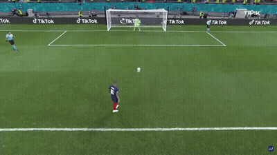 A Soccer Player Kicking A Ball In Front Of A Goal With Tik Tok Advertisements GIF