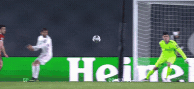 A Soccer Player Kicking A Ball In Front Of A Heineken Sign GIF