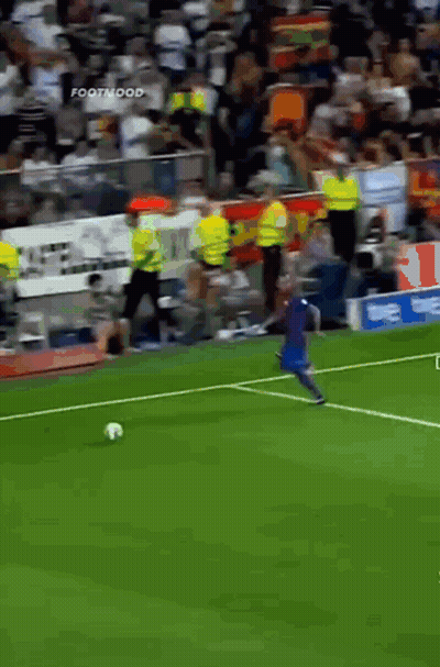 A Soccer Player Kicking A Ball On A Field With A Sign That Says Footmood In The Background GIF