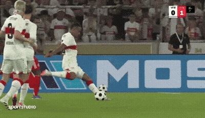 A Soccer Player Kicking A Soccer Ball In Front Of A Mos Sign GIF