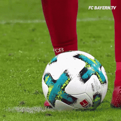 A Soccer Player Kicking A Soccer Ball On A Field . GIF