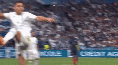 A Soccer Player Kicking A Soccer Ball On A Field With A Credit Agricole Banner In The Background GIF