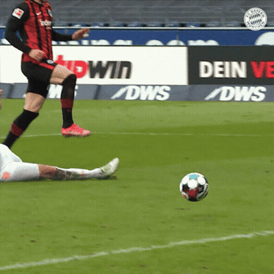 A Soccer Player Kicks A Ball In Front Of A Sign That Says Dws GIF