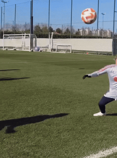 A Soccer Player Kicks A Ball On A Field That Has A Coca Cola Logo On His Shirt GIF