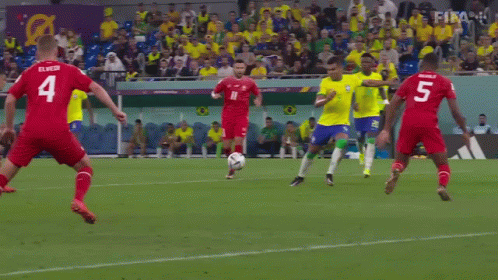 A Soccer Player Kicks The Ball In Front Of A Qatar Airways Banner GIF