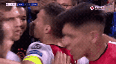 A Soccer Player Kisses Another Player On The Cheek During A Game Sponsored By Esporte Inferno GIF