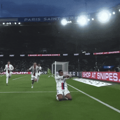 A Soccer Player Kneeling On The Field In Front Of A Paris Saint Germain Sign GIF