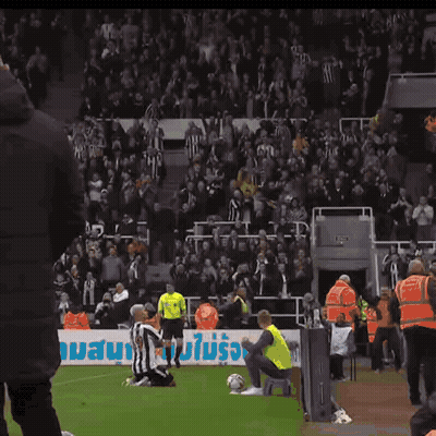 A Soccer Player Kneels On The Field In Front Of A Banner That Says ' Allianz ' GIF