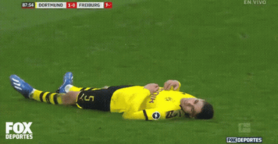 A Soccer Player Laying On The Field With The Fox Deportes Logo GIF