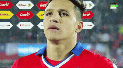 A Soccer Player Stands In Front Of A Display Of Logos For Claro And Canon GIF