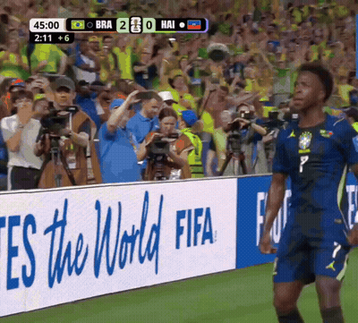A Soccer Player Stands In Front Of A Fifa Sign GIF