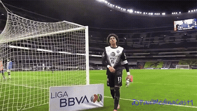A Soccer Player Stands In Front Of A Sign That Says Liga Bbva GIF